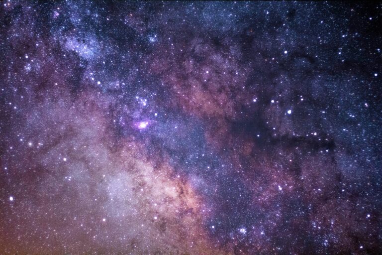 Colorful view of the Milky Way galaxy with bright stars and cosmic dust against a dark night sky.