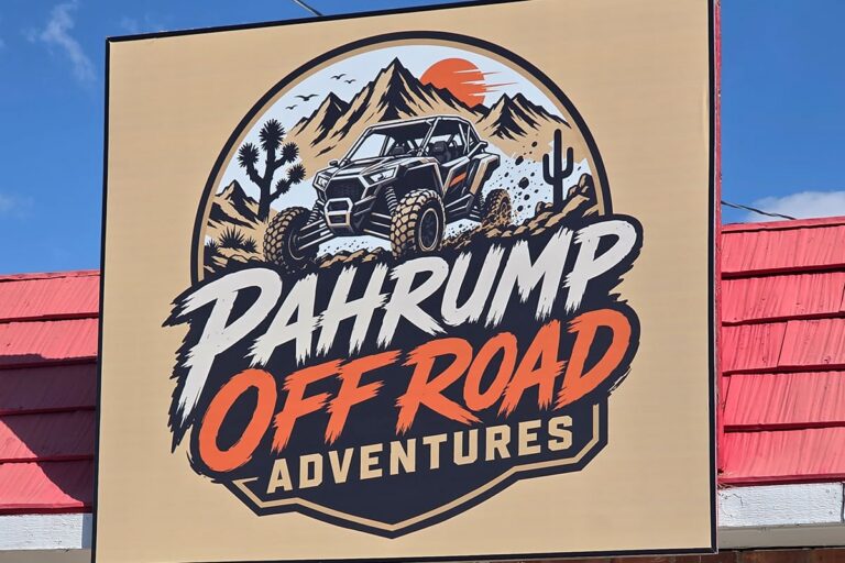 Sign for Pahrump Off Road Adventures featuring an illustration of an off-road vehicle in a desert landscape.